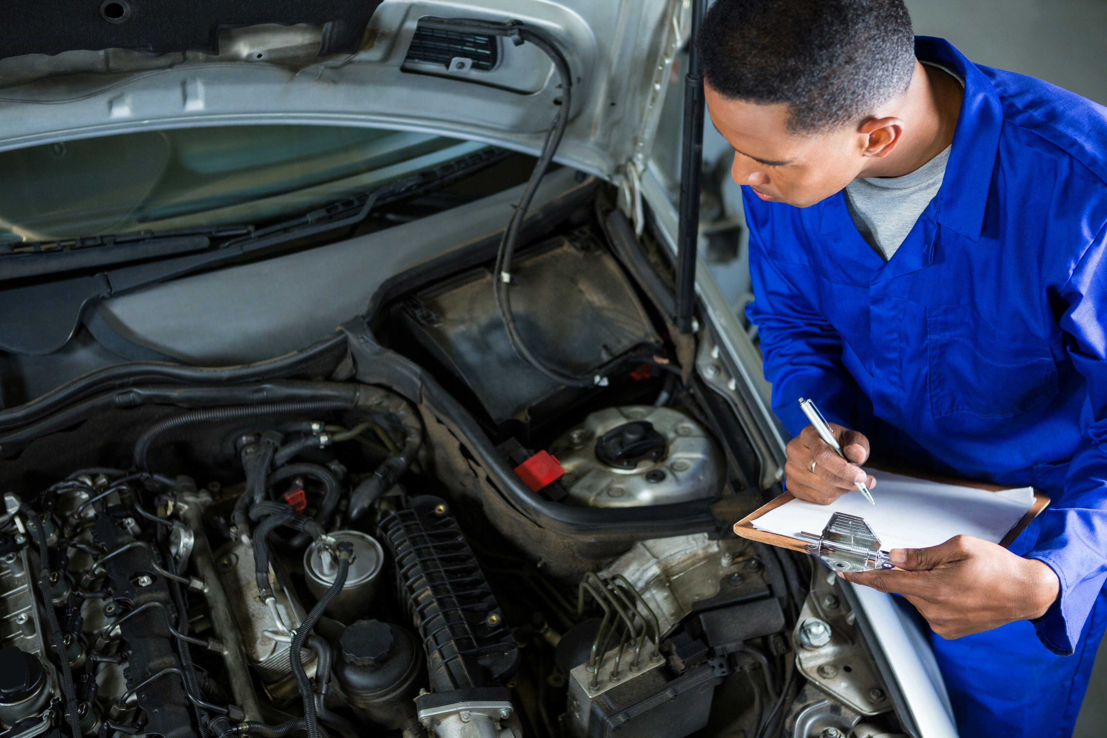 Mechanic working on car engine